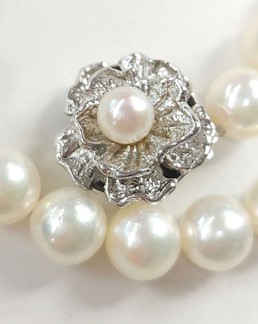Akoya Pearl Necklace featuring 7 mm white pearl beads, 42 cm length, laid out on a white background