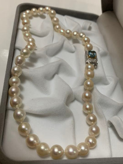 Akoya pearl baroque necklace with 42 pearls, K18WG YG clasp, and a large aquamarine stone