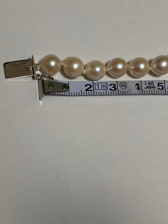 Akoya pearl baroque necklace with 42 pearls, K18WG YG clasp, and a large aquamarine stone