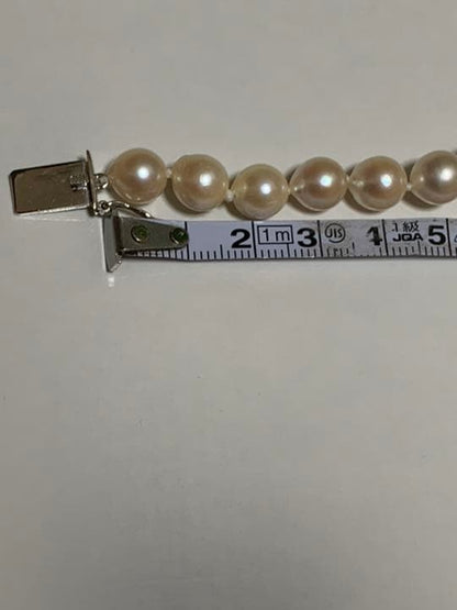 Akoya pearl baroque necklace with 42 pearls, K18WG YG clasp, and a large aquamarine stone