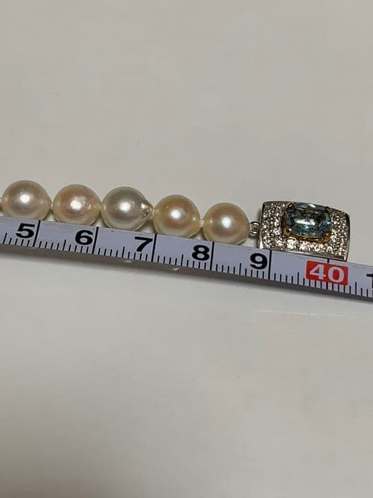 Akoya pearl baroque necklace with 42 pearls, K18WG YG clasp, and a large aquamarine stone