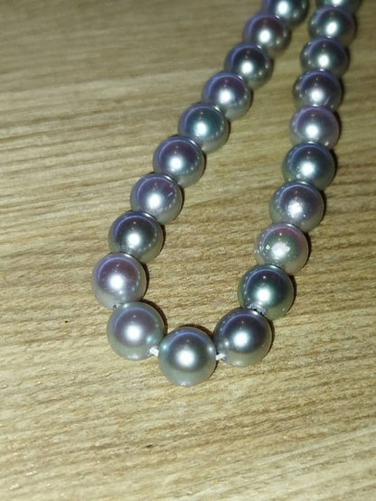 Elegant Akoya pearl necklace featuring lustrous white round pearls on a delicate chain