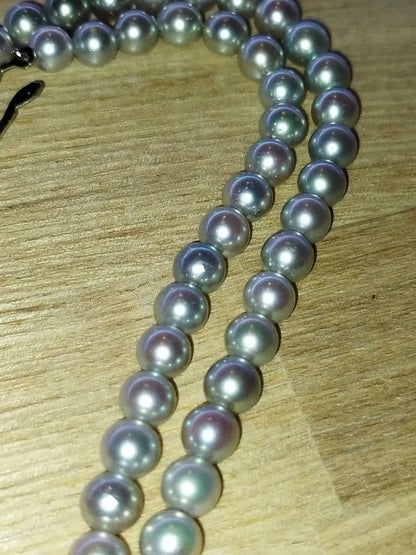 Elegant Akoya pearl necklace featuring lustrous white round pearls on a delicate chain