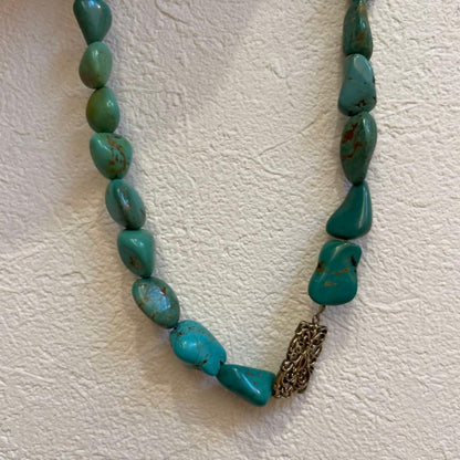 Agete necklace featuring 25 turquoise stones and 1 ruby stone with K10 gold-plated chain and openwork design