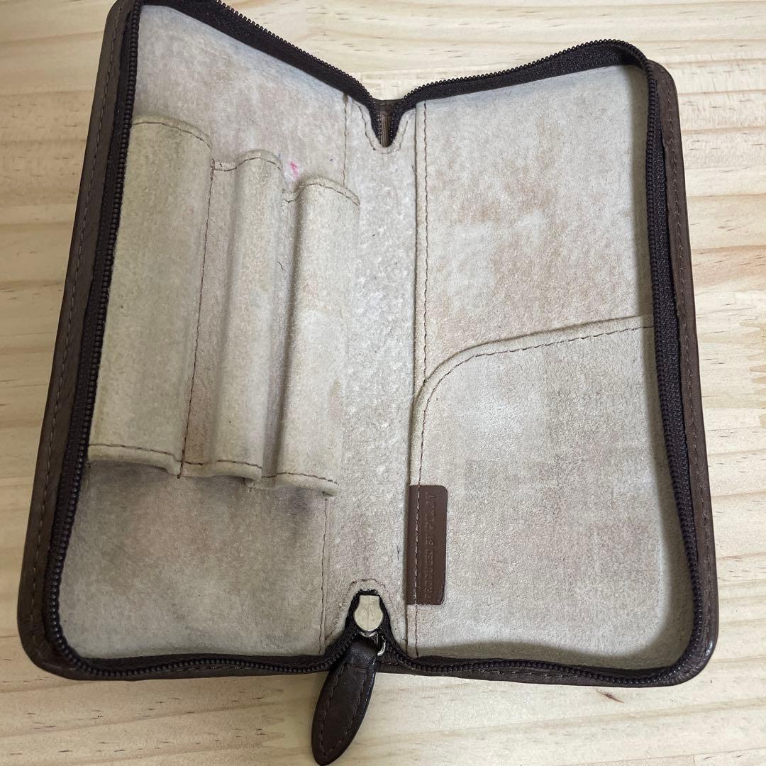 Brown leather Pilot pen case with zipper holding three pens and one pocket