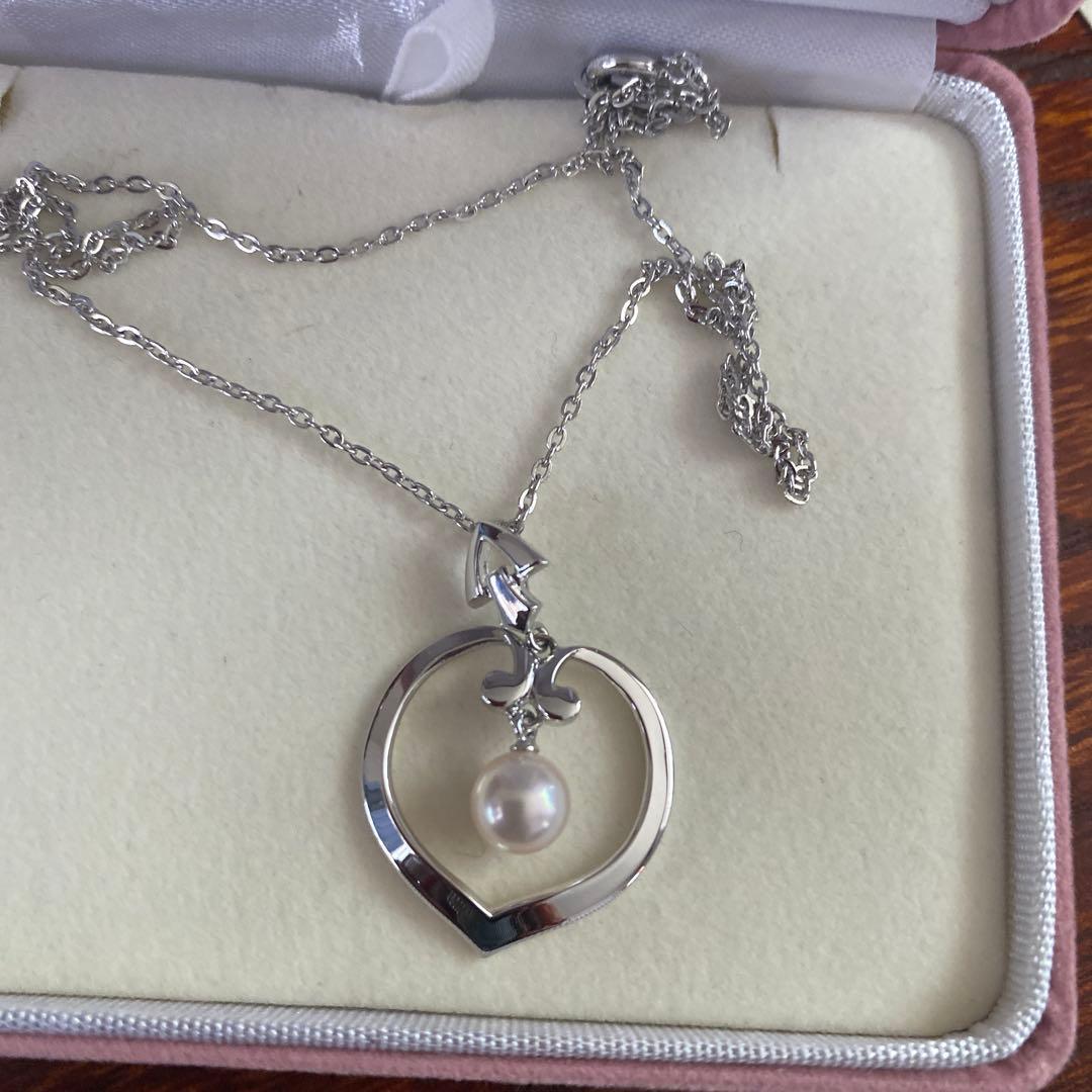 Silver TASAKI freshwater pearl pendant with certificate included on white background