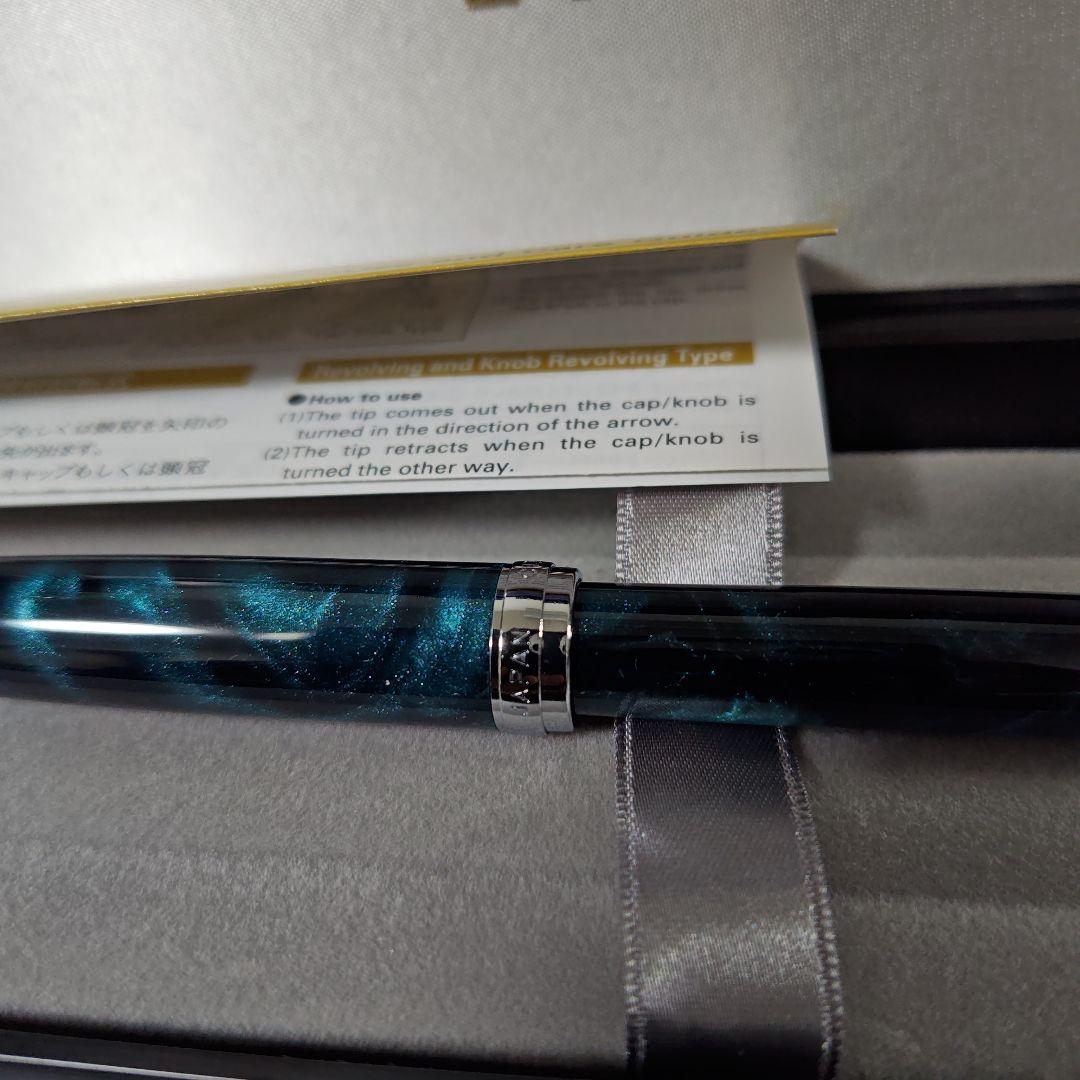 Close-up of a PILOT oil-based ballpoint pen with blue ink and a comfortable grip
