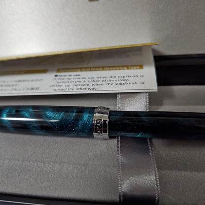 Close-up of a PILOT oil-based ballpoint pen with blue ink and a comfortable grip
