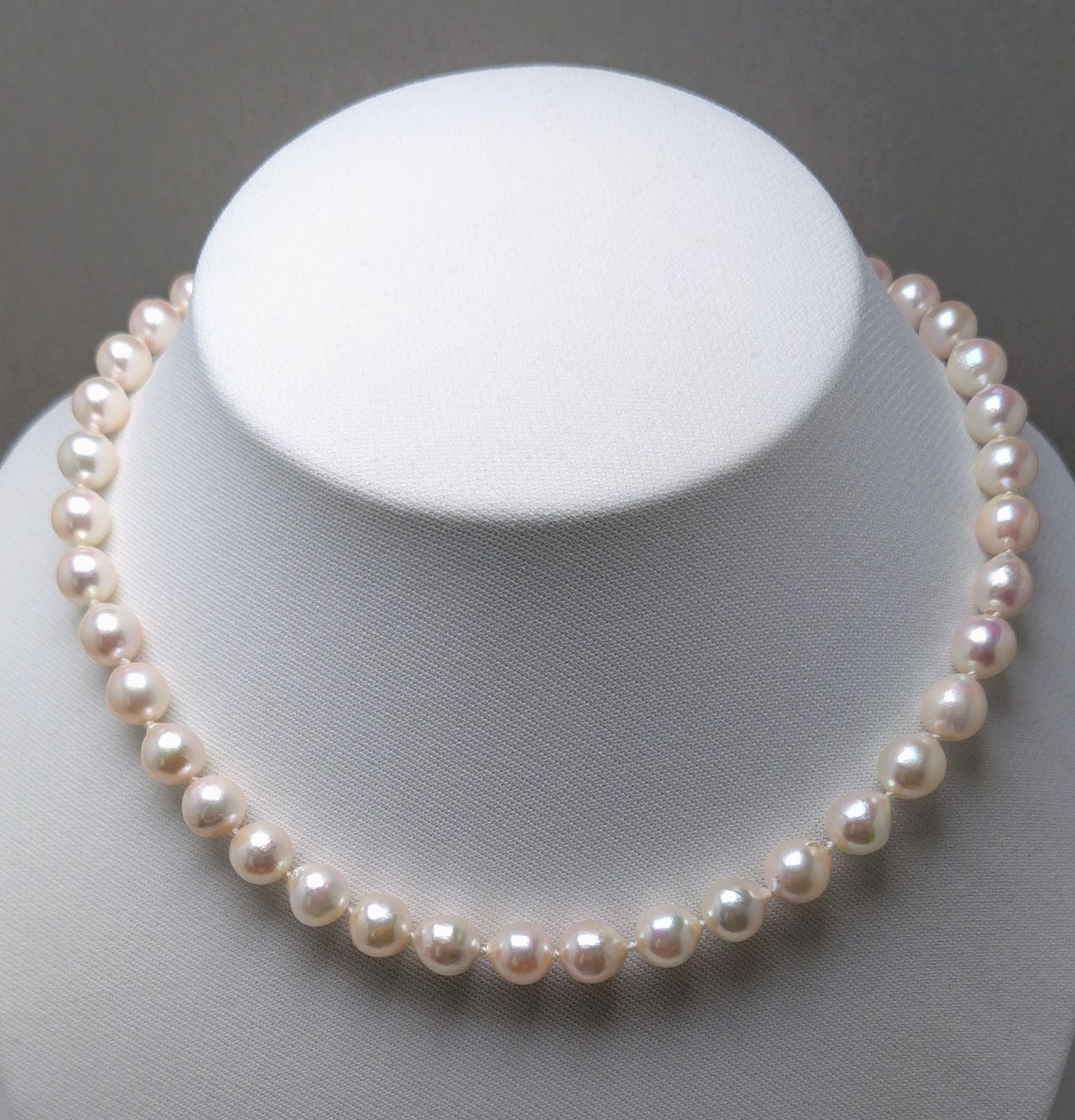 Akoya pearl necklace featuring 9.0-8.5mm white pink semi baroque pearls with unique indentations and good luster