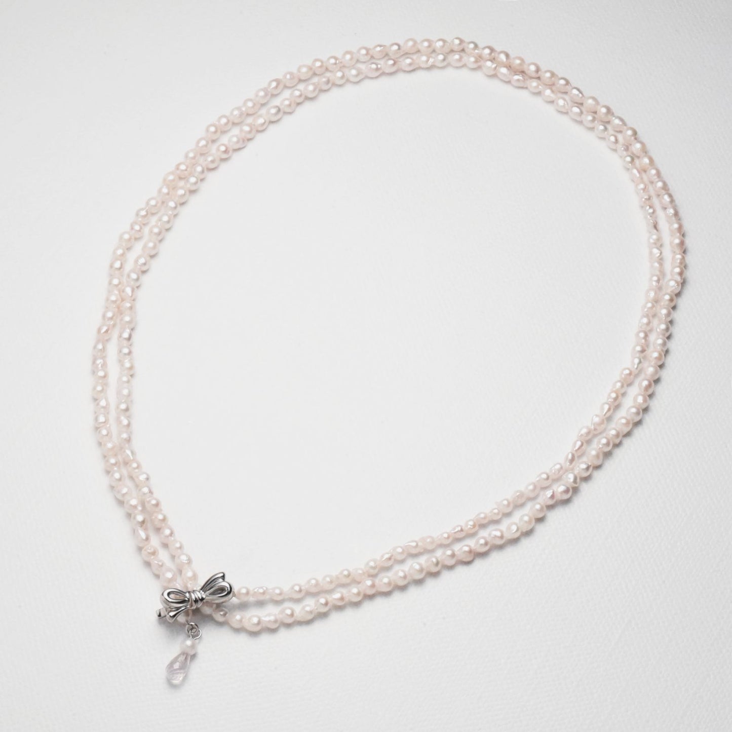Baroque shape Akoya pearl necklace with 3-3.5mm pearls and rose quartz ribbon clasp, 80cm long