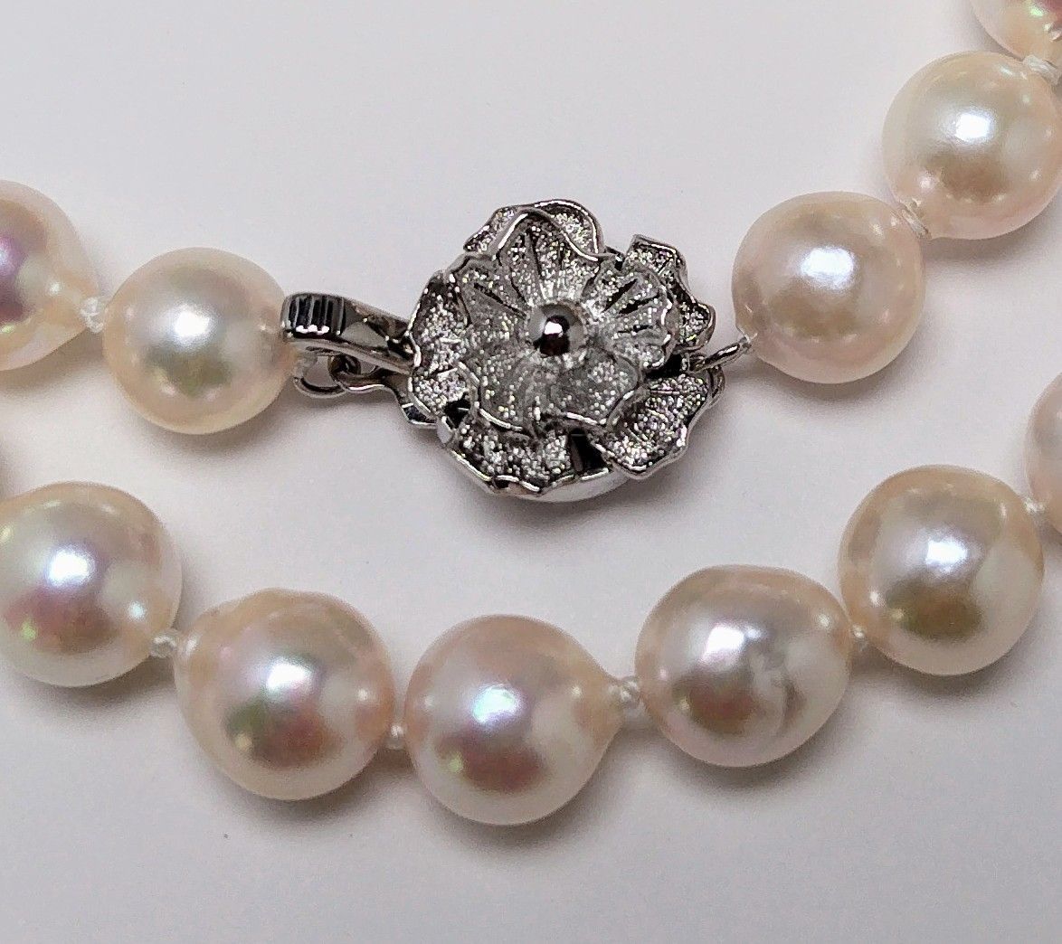 Akoya pearl necklace featuring 9.0-8.5mm white pink semi baroque pearls with unique indentations and good luster