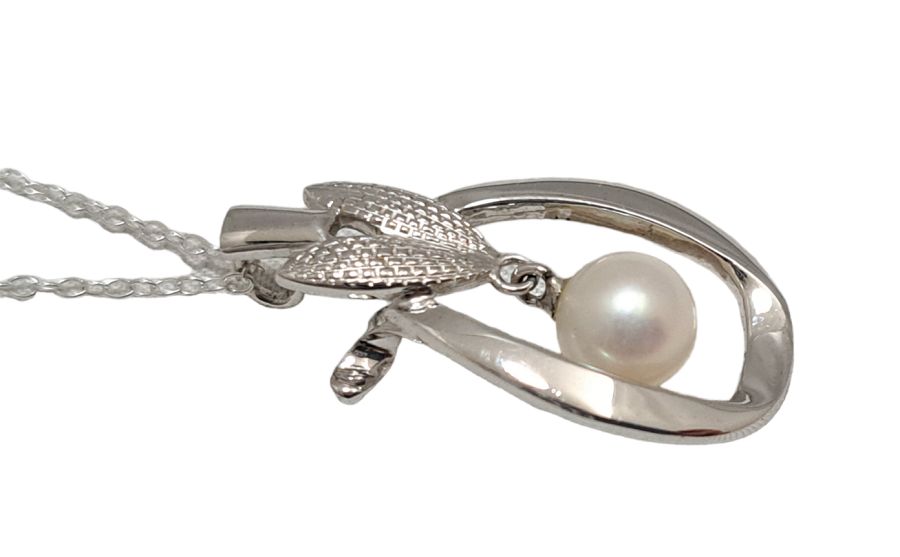 Mikimoto pearl pendant head with 6.5mm pearl on SV925 silver setting measuring 1.5x3 cm displayed on white background