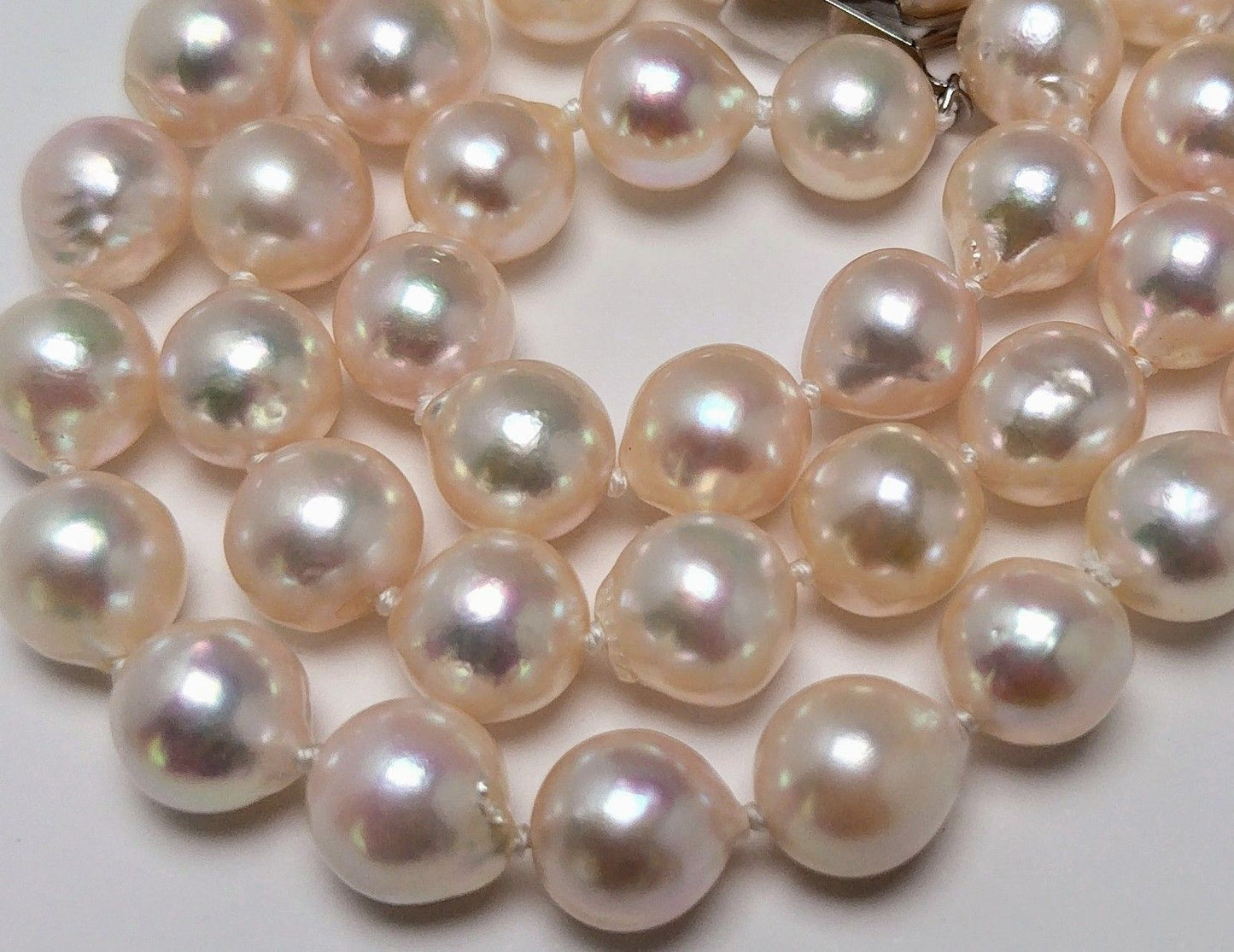 Akoya pearl necklace featuring 9.0-8.5mm white pink semi baroque pearls with unique indentations and good luster