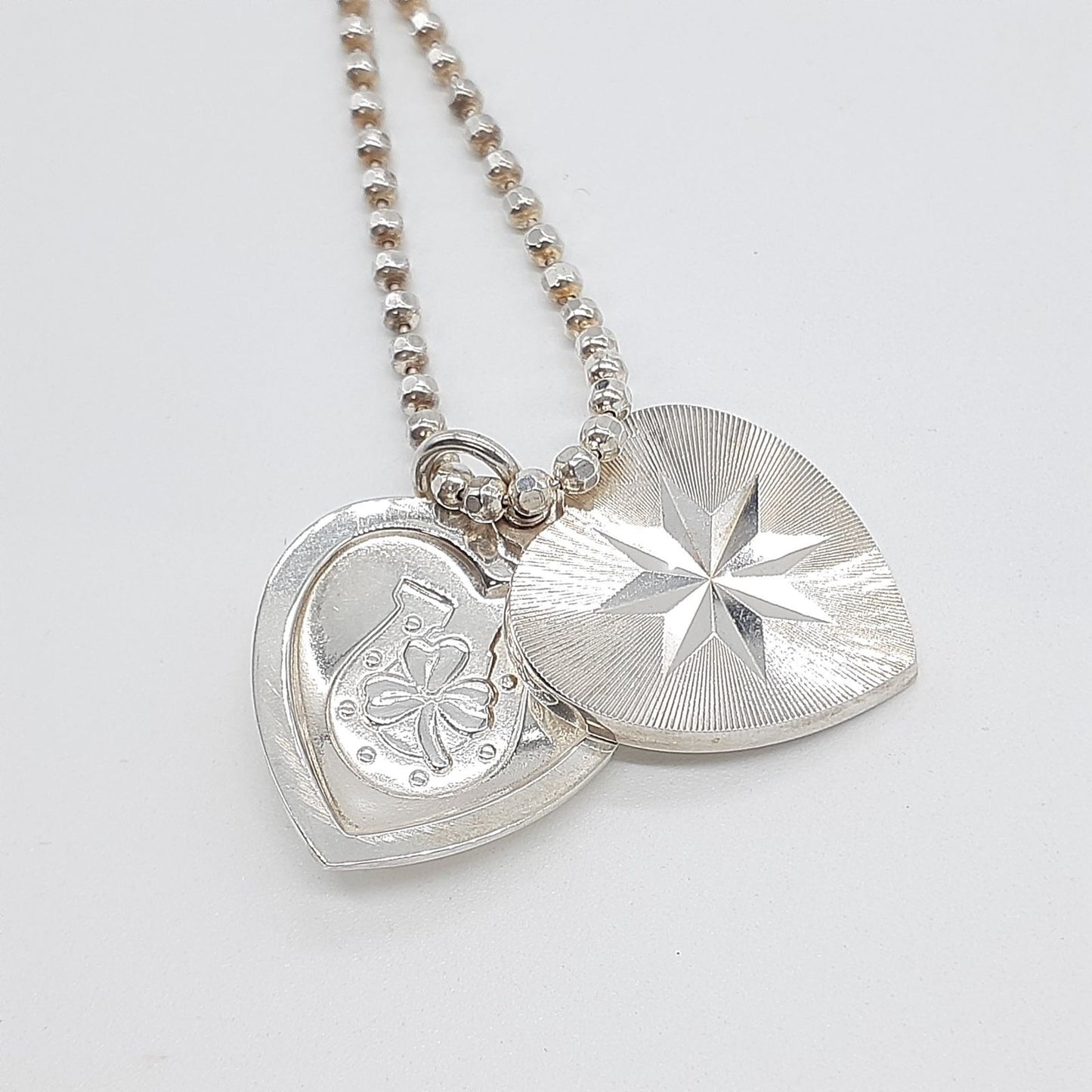 Agete heart-shaped silver necklace with heart rocket and clover charm on silver chain