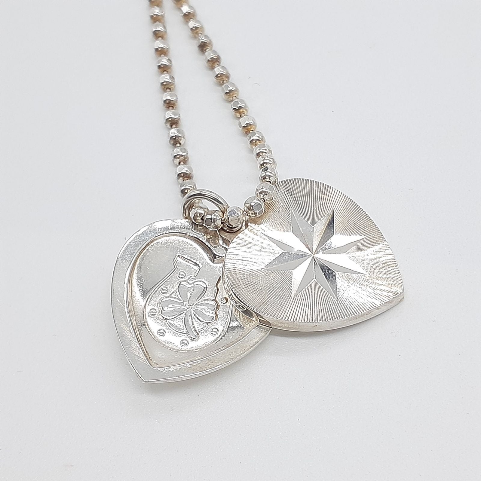 Agete heart-shaped silver necklace with heart rocket and clover charm on silver chain