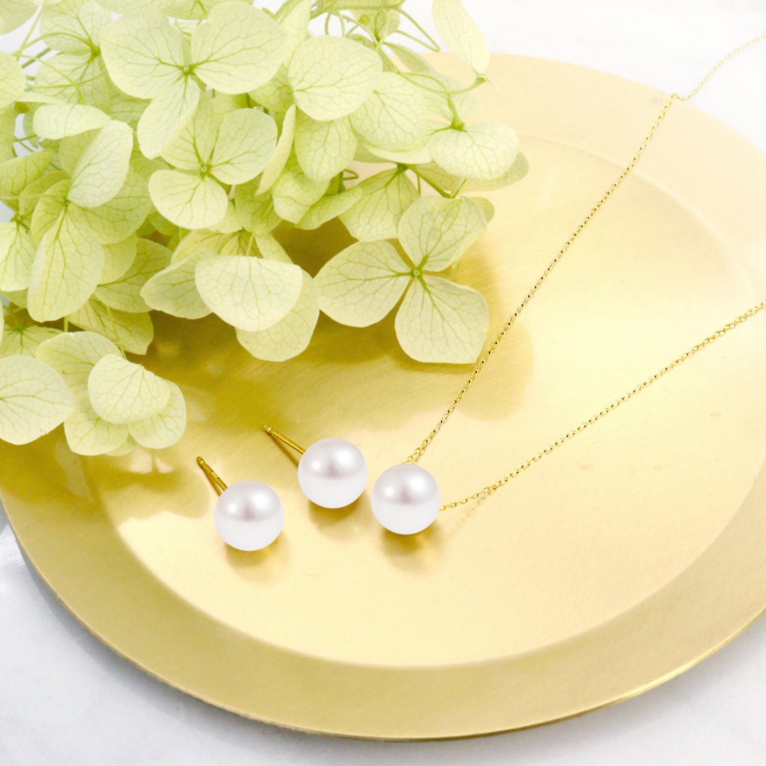 Necklace and earring set featuring 7-8mm Akoya pearls and a preserved rose in a jewelry case