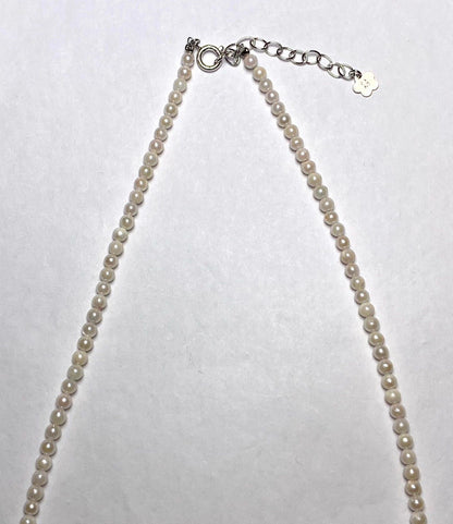 Akoya pearl baby pearl necklace with 3.0-3.5mm pearls and silver adjuster on white background