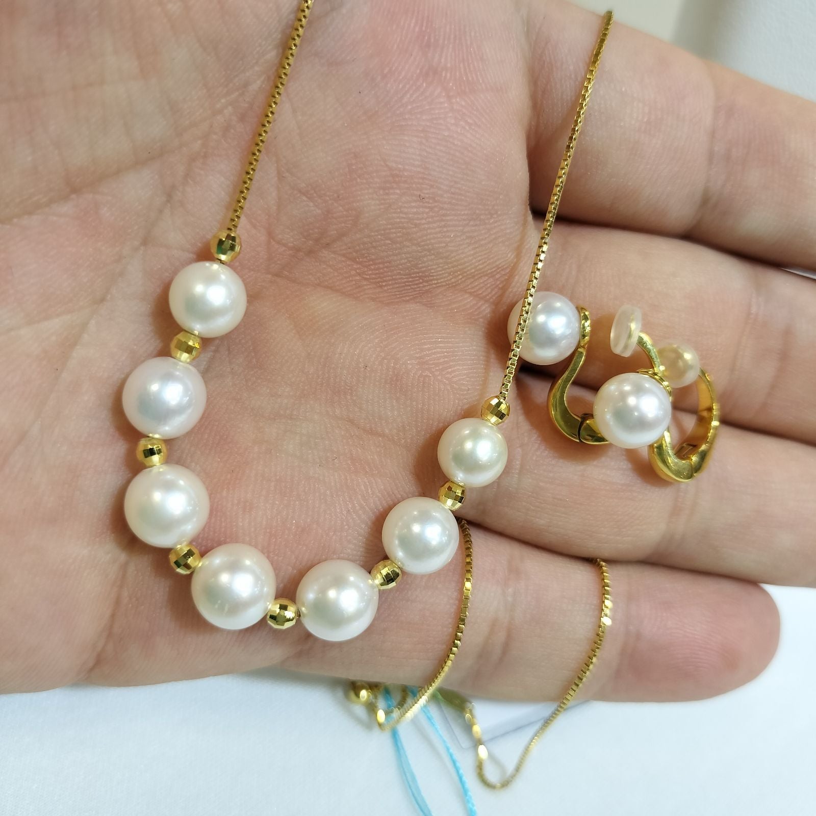 Akoya pearl necklace with 7-7.5 mm pearls and matching 7.5 mm pearl earrings on white background
