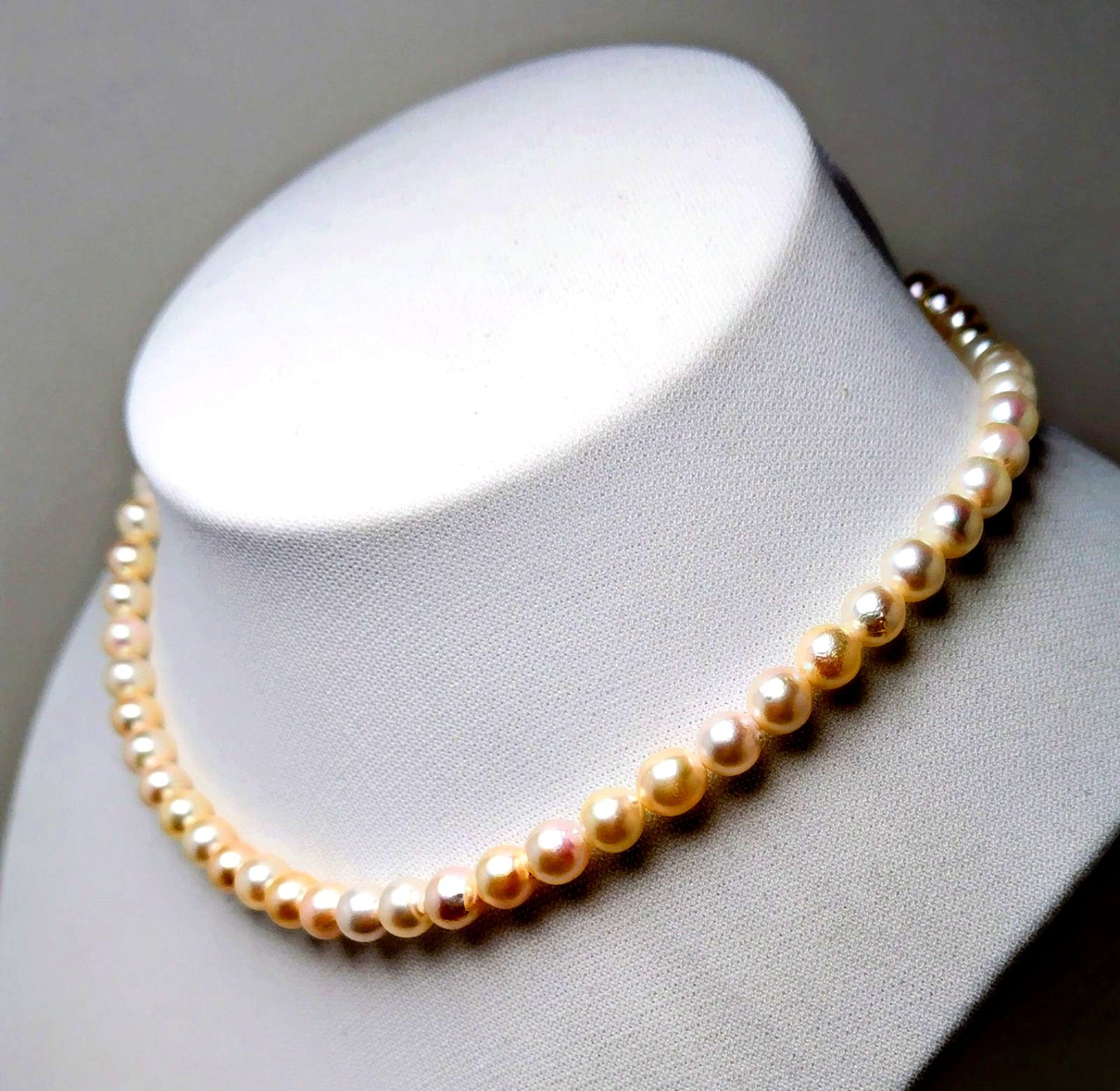 Akoya pearl necklace with 6.5 to 7.0 mm white pink semi-baroque pearls showing natural indentations and good luster