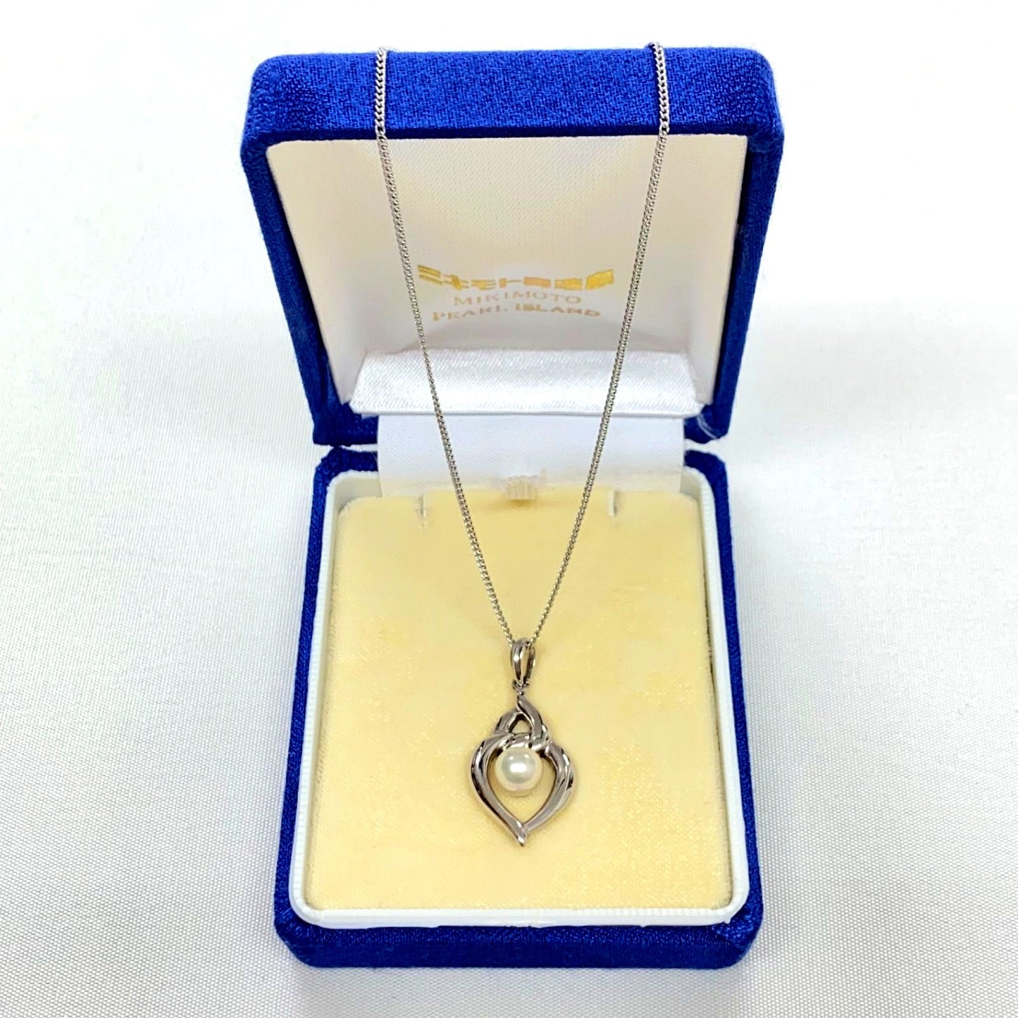 Mikimoto pearls necklace showing white pearls with slight cloudiness due to aging