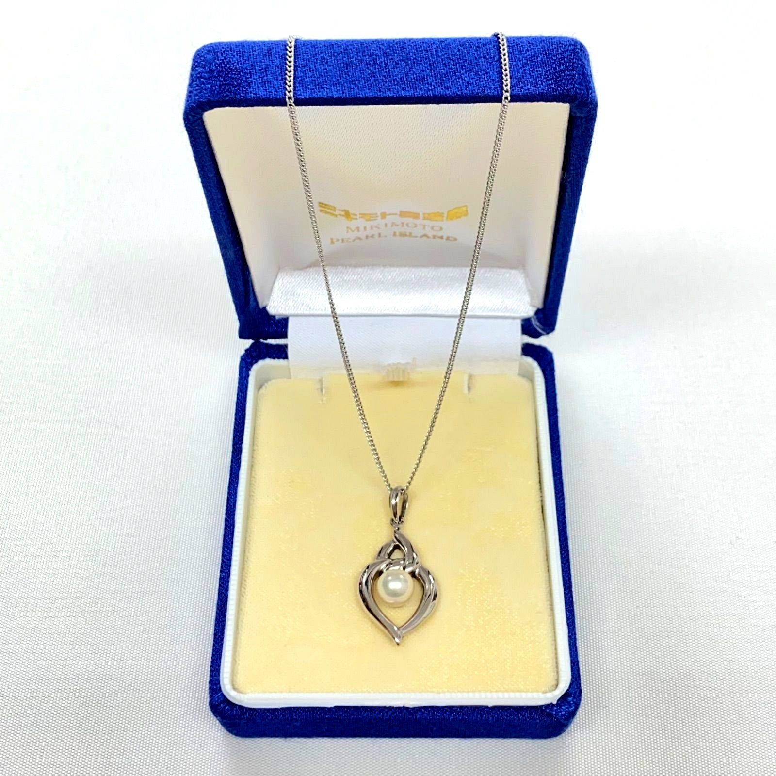 Mikimoto pearls necklace showing white pearls with slight cloudiness due to aging