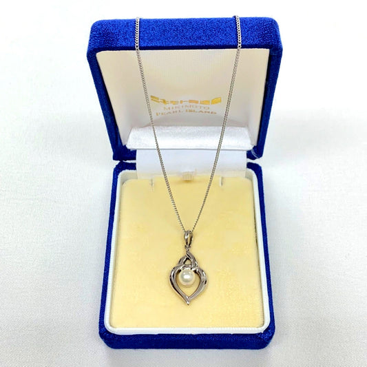Mikimoto pearls necklace showing white pearls with slight cloudiness due to aging
