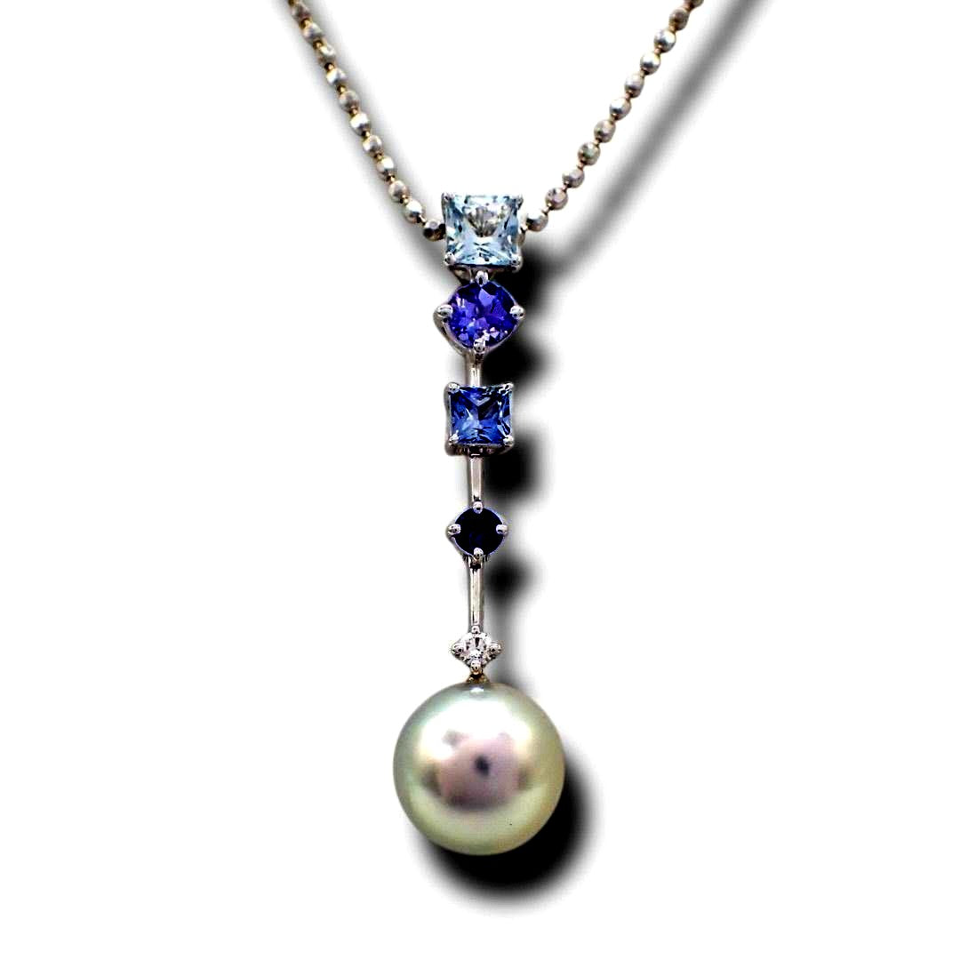 Tasaki pearl necklace with drop pendant featuring diamonds and colored gemstones on a white gold chain