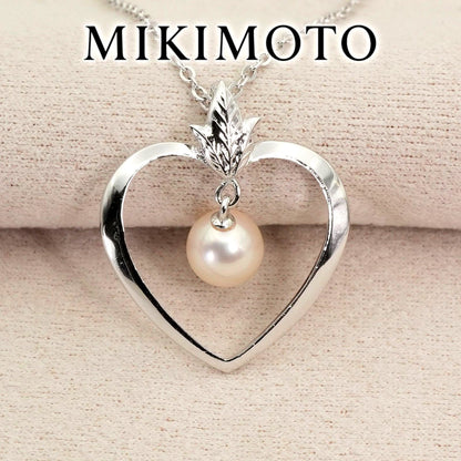 Mikimoto heart-shaped pearl necklace with silver chain displayed against white background