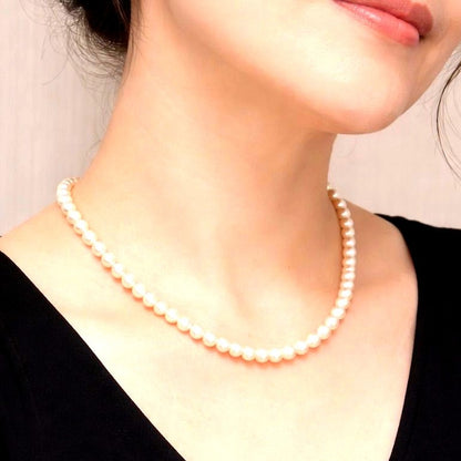 Akoya pearl necklace with 6mm real pearls and silver clasp displayed on a white background