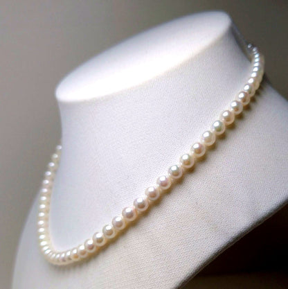 Akoya pearl necklace featuring round 5.5-6.0mm white, green, and pink pearls with good luster
