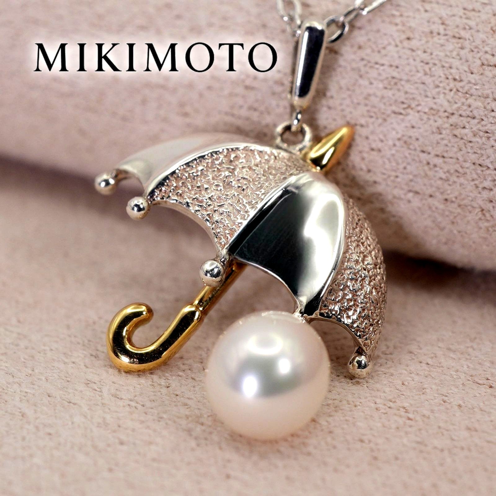 Mikimoto Umbrella Necklace made of silver, K18 gold, and pearl shown on a white background