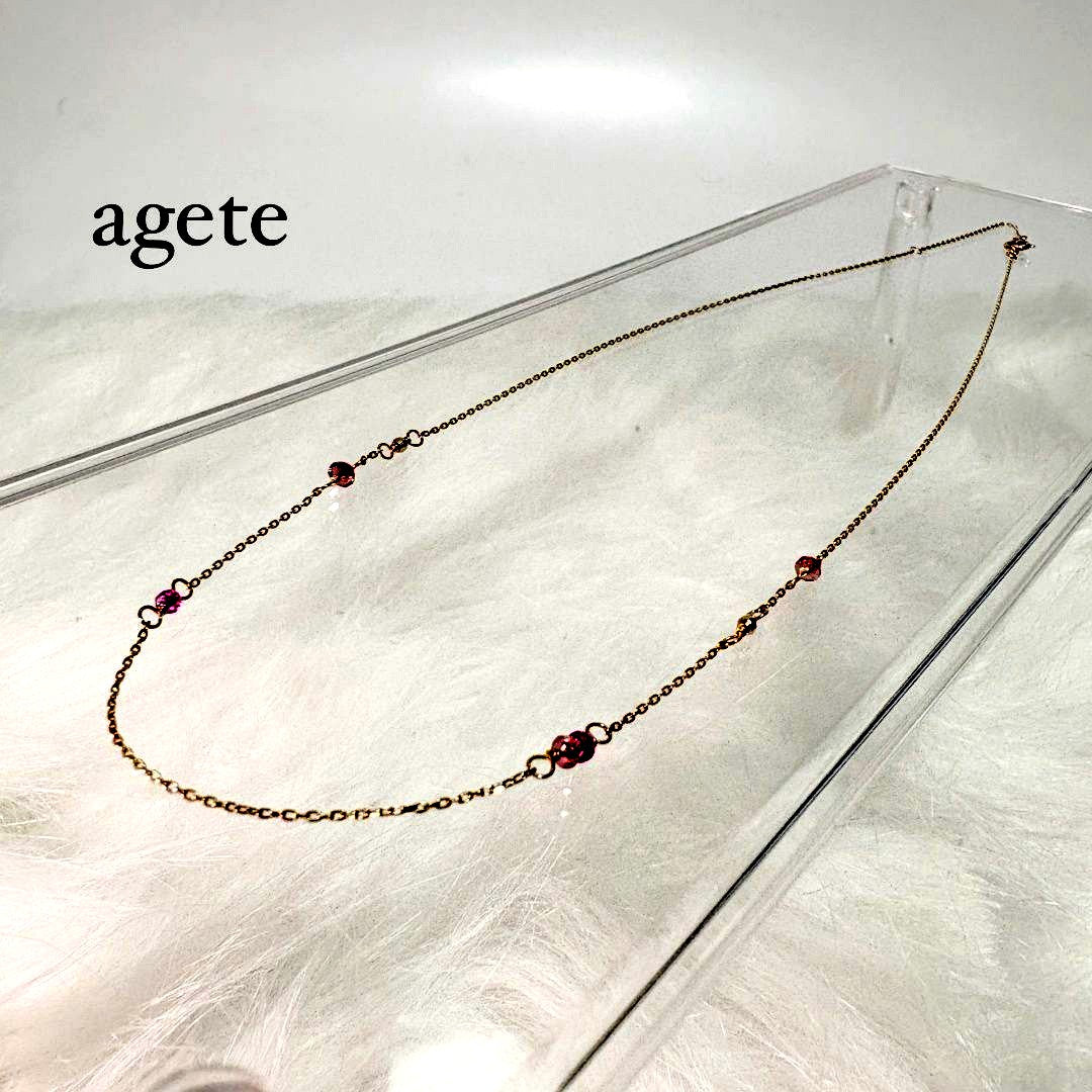 Agete K10 gold necklace with a pink colored stone pendant on a delicate gold chain