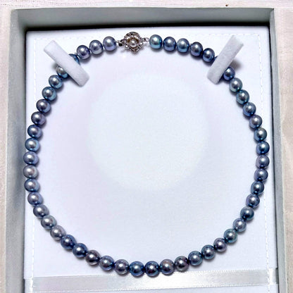 Honmei pearl necklace featuring 8mm blue gray pearls and silver engraved clasp on a white background