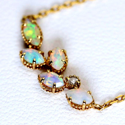 Valuable discontinued agate opal necklace with K18 and K14 gold and diamond accents on 5mm grid background