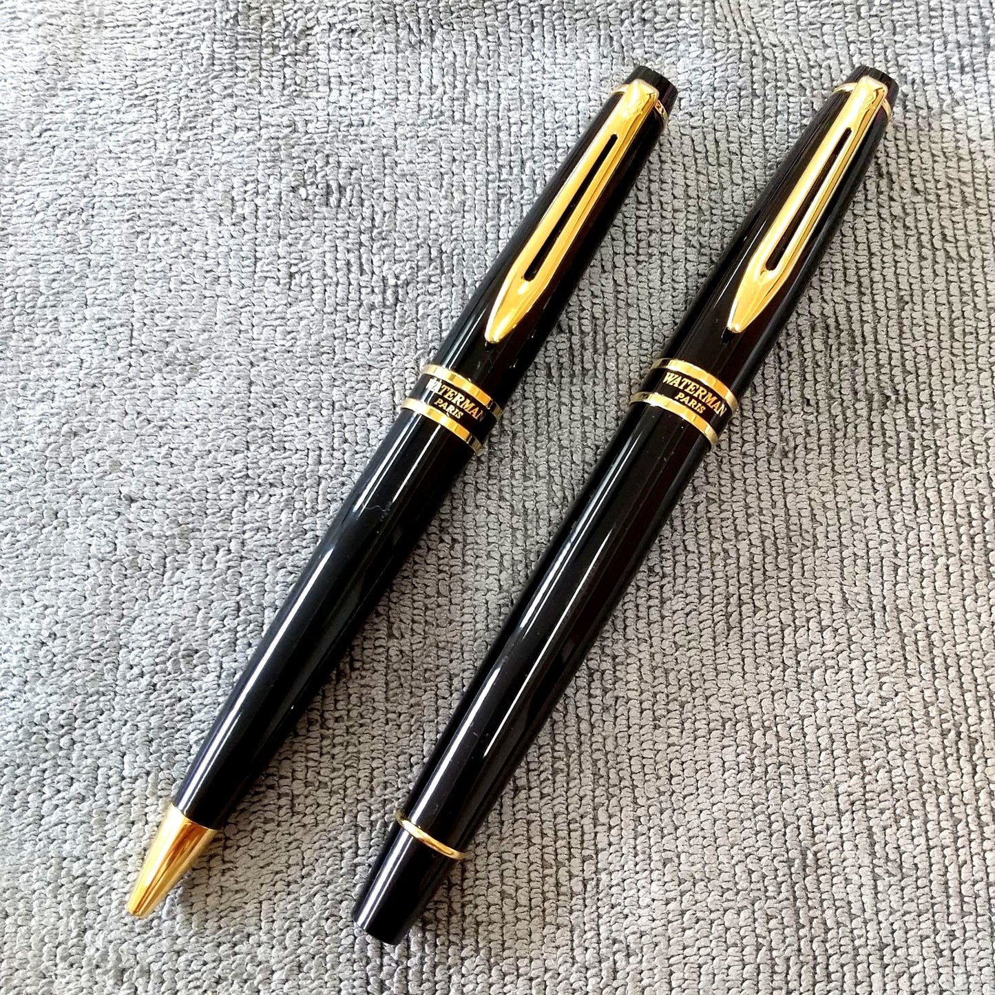 Used Waterman ballpoint pen and fountain pen set showing aged wear and ink residue