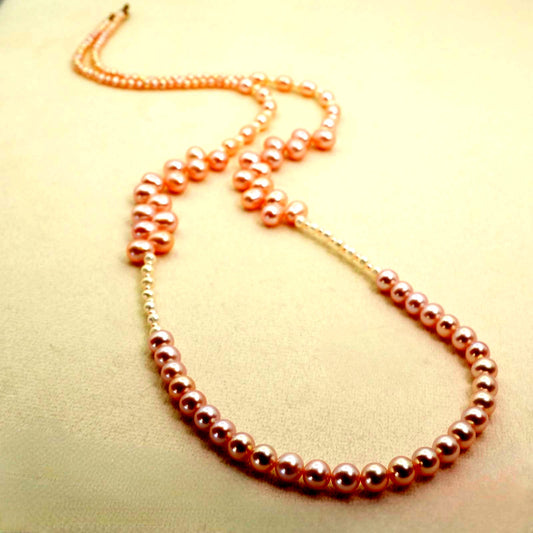 Agete K10 gold long necklace featuring pink freshwater pearls displayed on white background