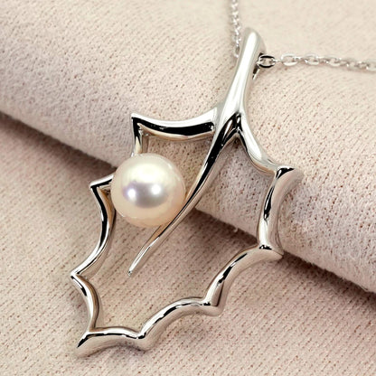 Mikimoto Hollyhock necklace featuring a silver chain and a single pearl pendant with floral design