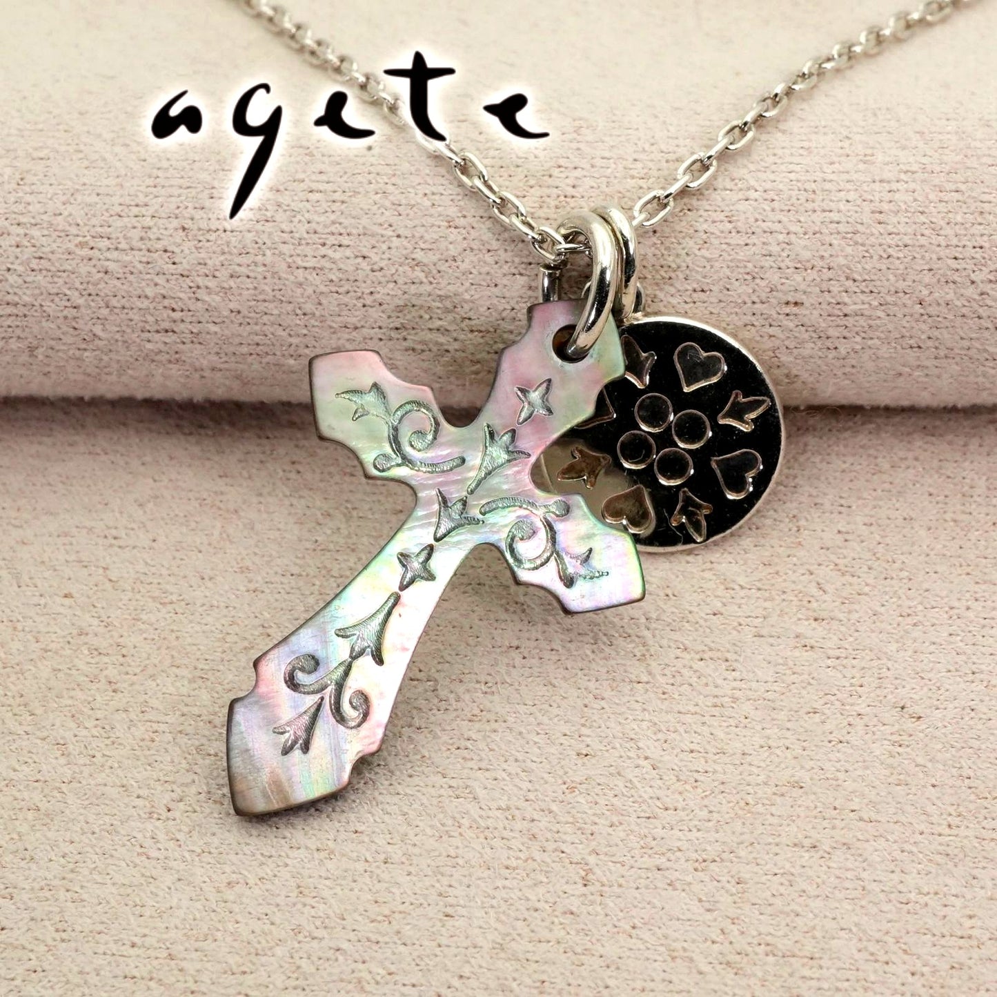 Agete silver necklace with a round shell cross charm on a delicate chain