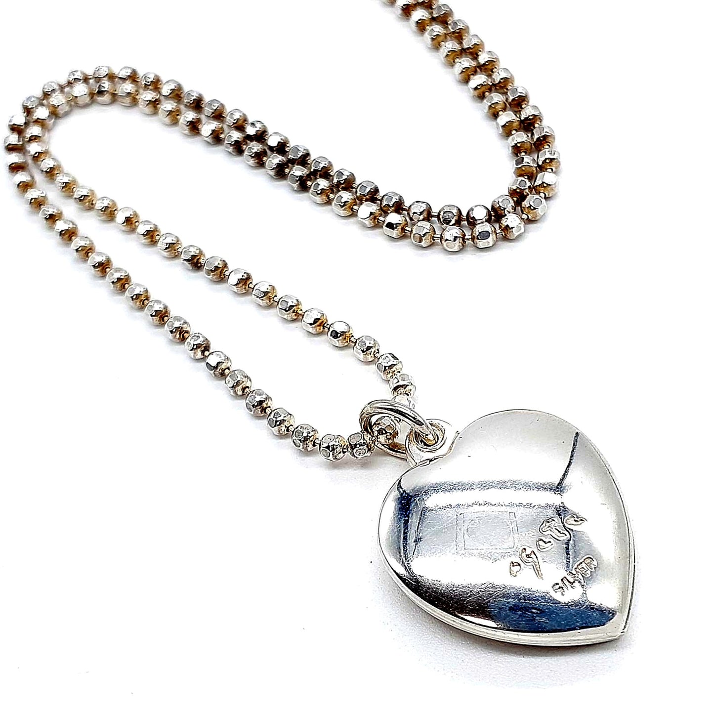 Agete heart-shaped silver necklace with heart rocket and clover charm on silver chain