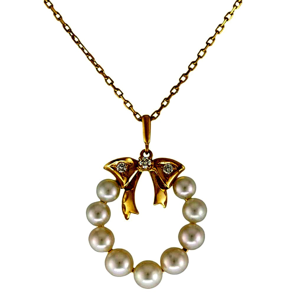 Mikimoto 18K yellow gold necklace featuring a single Akoya pearl and diamond accents for ladies