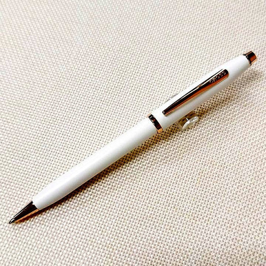 Cross Century II ballpoint pen with pearl white lacquer body and rose gold clip on white background