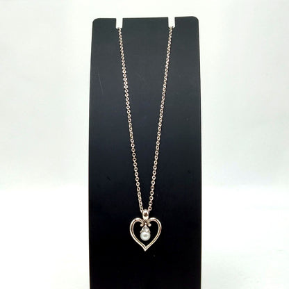 MIKIMOTO silver heart necklace with a 0.5cm pearl pendant and 19cm chain on white background