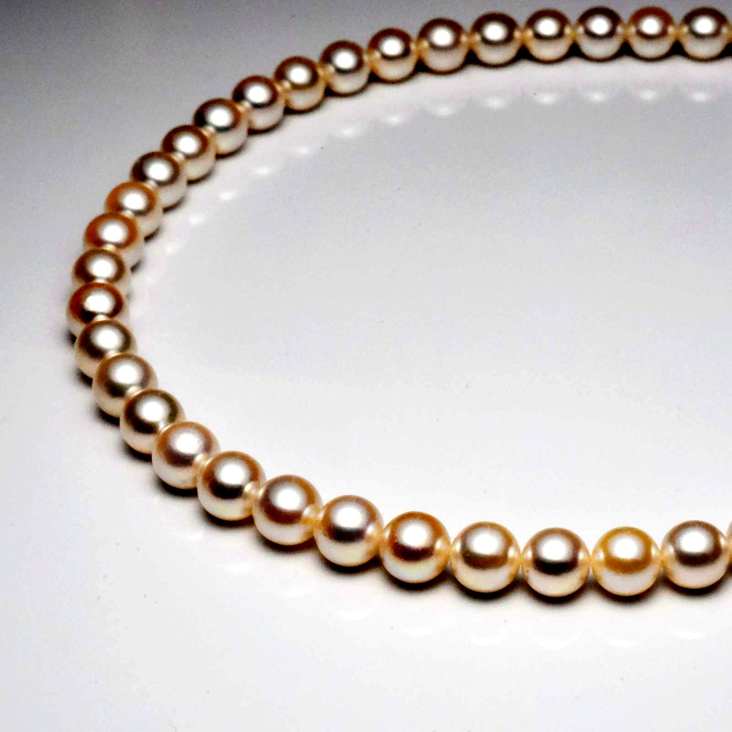 Akoya pearl necklace with 7.5-8mm pearls measuring 42cm in length on a white background