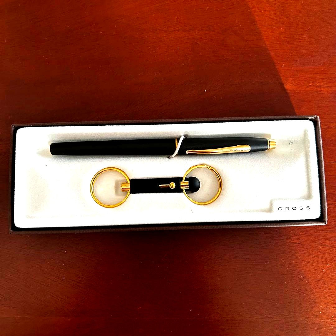 Used Cross black ballpoint pen and keychain set with gift box showing minor scratches and signs of use