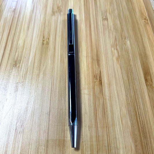 PILOT Quattro black ballpoint pen shown with cap and medium point tip