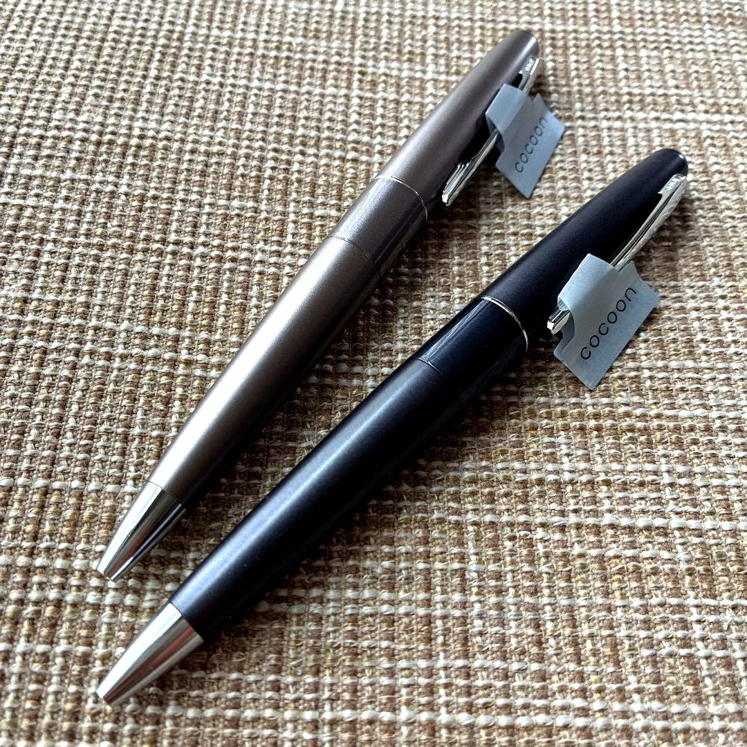 Two-piece set of Pilot Cocoon ballpoint pens with black ink and gray barrel shown side by side