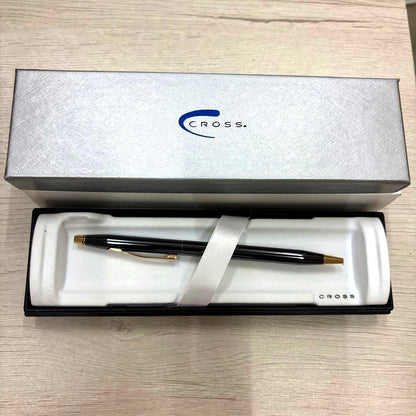 Cross black ballpoint pen with gold accents displayed alongside its dedicated black case