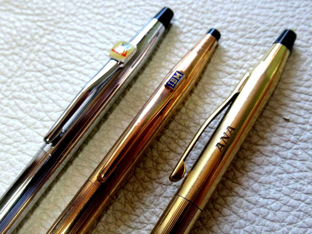 Set of three Cross Classic Century metal ballpoint pens on white background