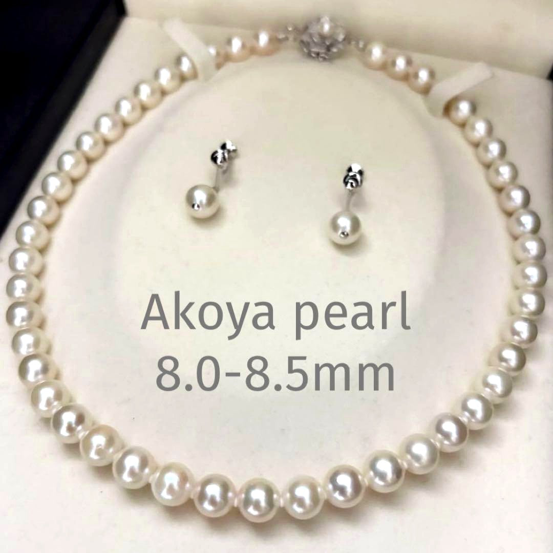 Large white Akoya pearl necklace and matching earrings with 8.5mm pearls and silver accents on white background