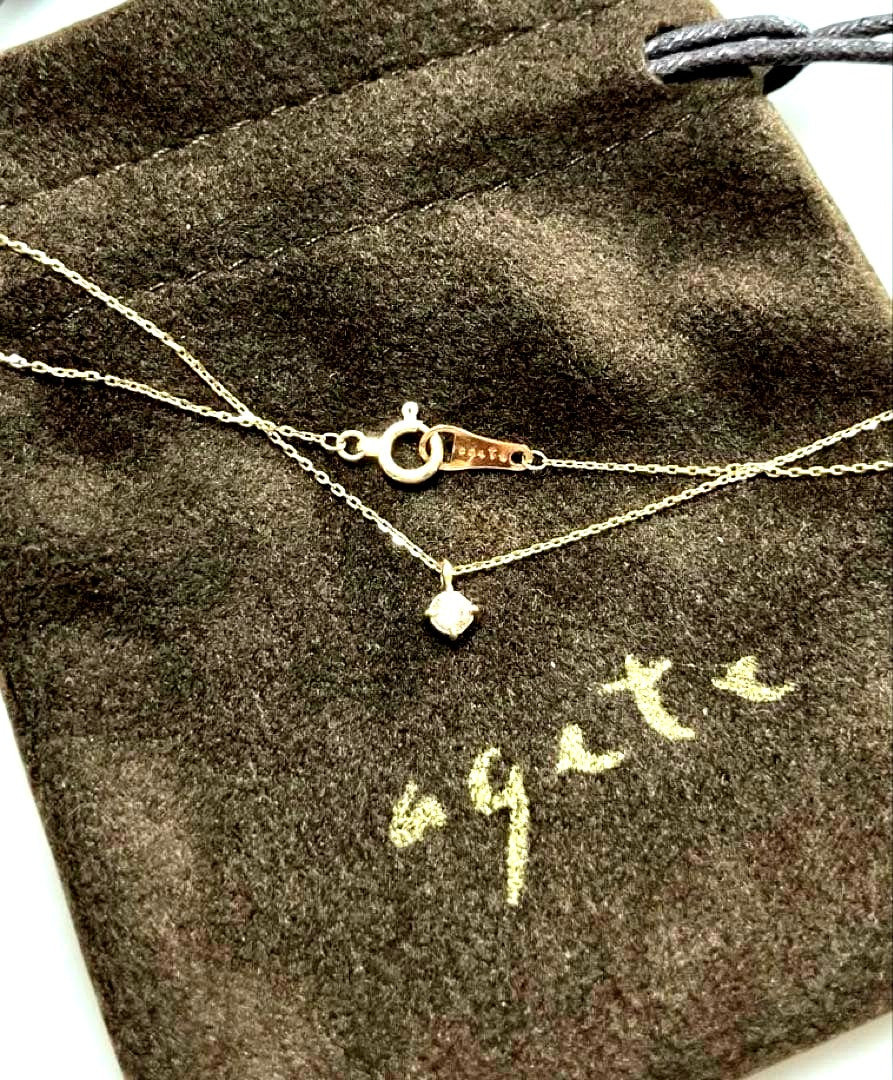 K10 gold diamond necklace by agete with 0.07 carat diamonds displayed on white background
